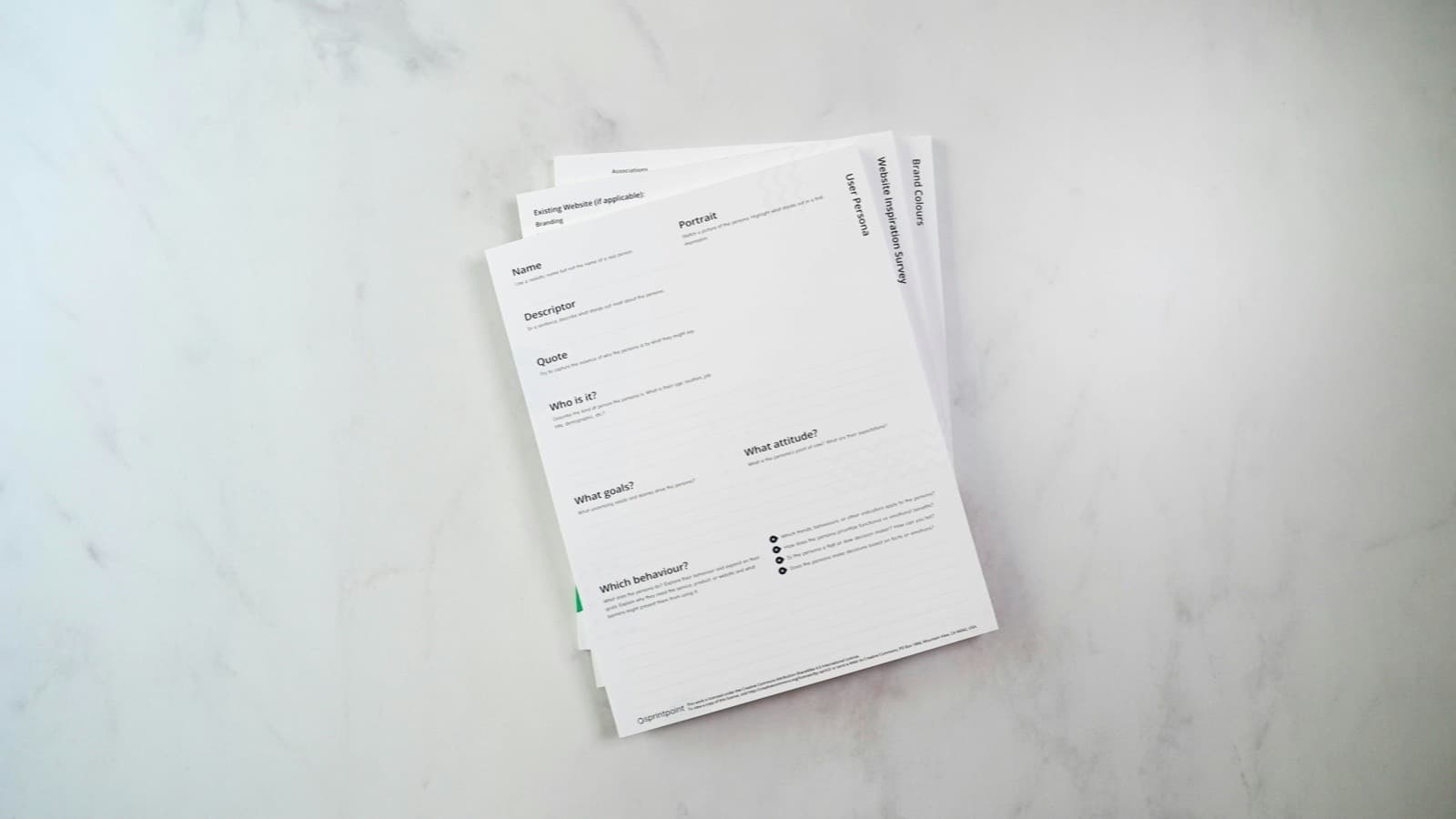 A pile of printed documents lying on a white counter