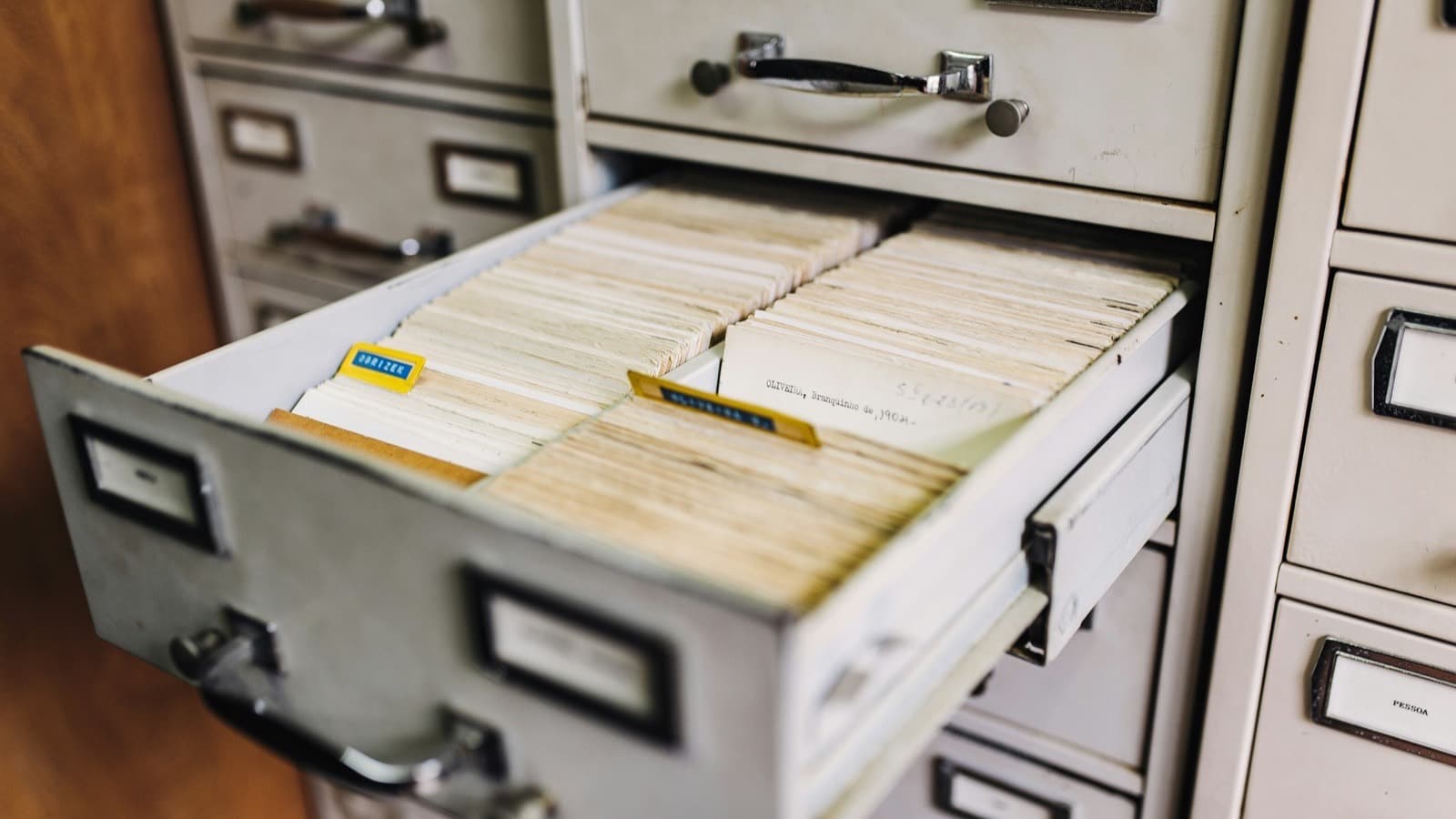 An open filing cabinet drawer full of labelled hanging folders
