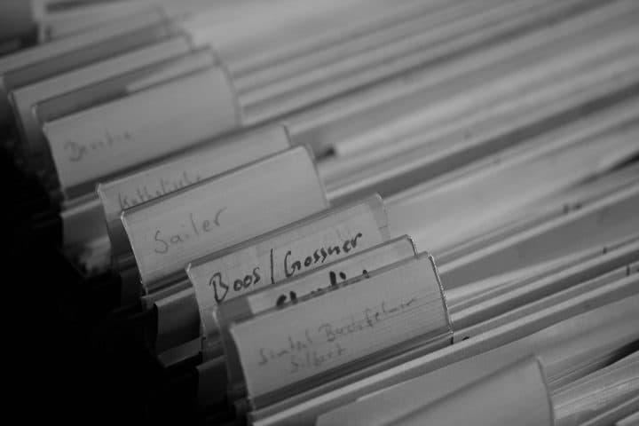 A bundle of handwritten and printed pages held together